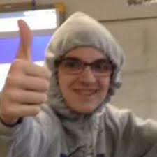 smiling boy giving a nerdy thumbs up
