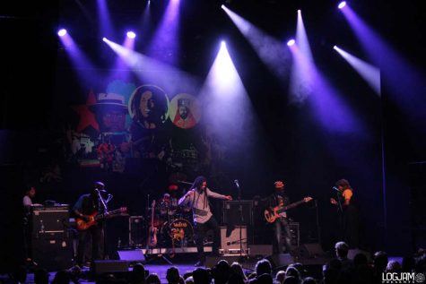 A full band onstage with lights.