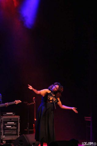 Woman singing expressively at microphone