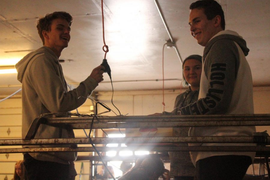 students smile while working in a shop