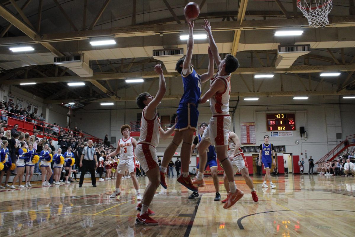 Big Sky player Josiah Boone reaches up for the ball to get the rebound while surrounded by Hellgate players during the boys' game. 