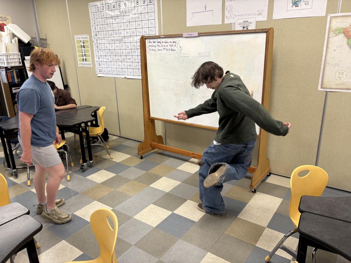 Calen Goodian and Paxton Parks playing hacky sack in Big Sky High School, May 2026. 